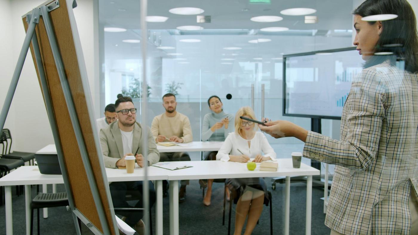 A trainer presenting to a group in a modern office